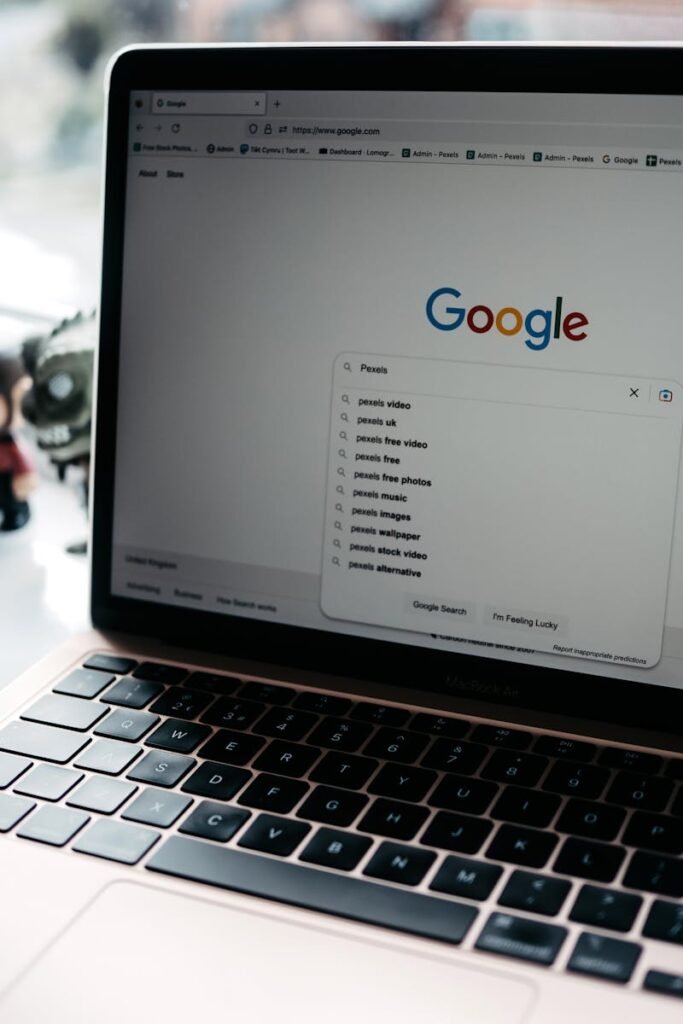 A close-up shot of a laptop displaying a Google search page with related searches visible.